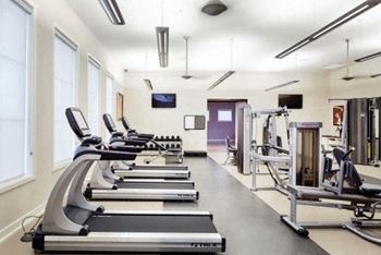 A gym with treadmills and other exercise equipment